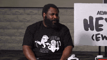 a man with a beard wearing a black shirt that says crazy