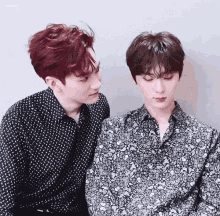 two young men with red hair are looking at each other
