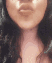 a close up of a woman 's face with a kiss on her lips