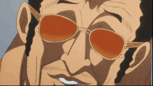 a close up of a man 's face wearing orange sunglasses