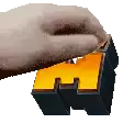 a person 's hand is holding a piece of wood with the letter h on it .