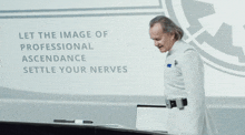a man in a white uniform is standing in front of a sign that says let the image professional ascendance settle your n