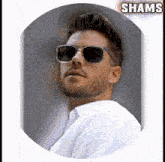 a man wearing sunglasses is in a circle with shams on the bottom
