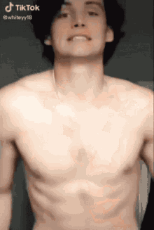 a shirtless man 's chest is shown in a tiktok