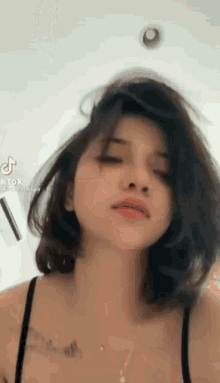 a close up of a woman 's face with her eyes closed .