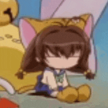 a girl with cat ears is sitting on the floor next to a stuffed animal .