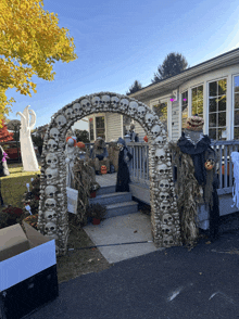 a house decorated for halloween with a large skull arch