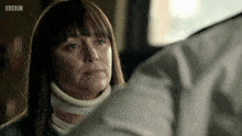 a woman wearing a neck brace looks at a man in a bbc advertisement