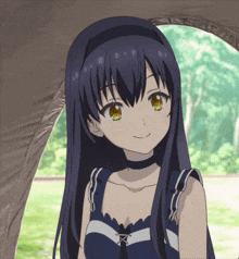 a girl with long blue hair and yellow eyes is smiling in front of a tent