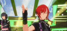 a man with red hair and black gloves is standing on a stage