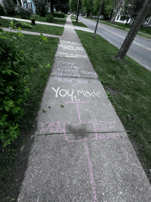 a sidewalk with chalk written on it that says " you made "