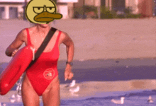 a woman in a red swimsuit carrying a life preserver