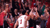 a basketball player with the number 1 on his jersey jumps in the air