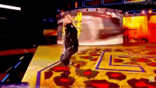 a man is standing on a stage with a leopard print rug and a yellow background .