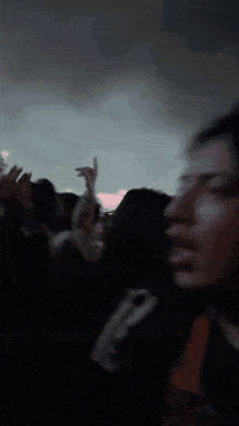 a blurry photo of a crowd at a concert with a person wearing a shirt that says ' n ' on it