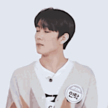 a young man wearing a sweater and a name tag that says ' gi '