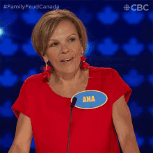 a woman wearing a red shirt and a blue badge that says ana