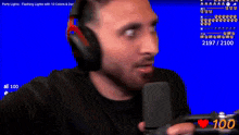 a man is wearing headphones and holding a video game controller while playing a game .