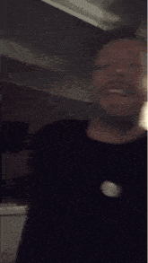 a man with a beard is making a face with his mouth open .