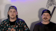 two men are standing next to each other with one wearing a shirt that says ' hate ' on it