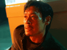 a close up of a man 's face with red eyes