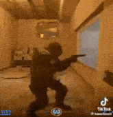 a man is holding a gun in a video game while standing in front of a window .