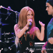 a woman singing into a microphone with the website walmart.com/soundche in the lower right corner