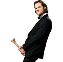 a man in a tuxedo is holding a bone in his hands