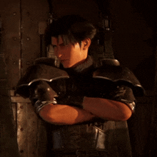 a man with his arms crossed stands in front of a wall with a battery on it