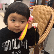 a little girl wearing a black shirt that says no old y