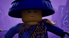 a lego ninjago character with a blue hat and a shirt that says ioioi