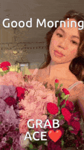 a woman is holding a large bouquet of flowers and says good morning grab ace .