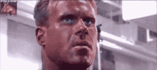 a close up of a man 's face with a picture of a man in the background that says follow