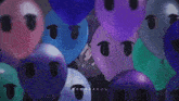 a bunch of balloons with faces on them with chinese writing on the bottom