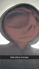a person wearing a hoodie and glasses has a caption that says voila voila je m 'occupe