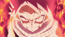 a close up of a fairy tail character with a scarf around his neck and a fire background .