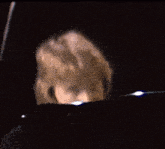 a man is playing a piano in a dark room