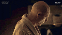 a bald man is shown in a hulu advertisement for nine perfect strangers