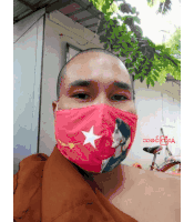 a bald man wearing a red mask with a white star