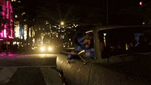 a woman is sitting in a car at night