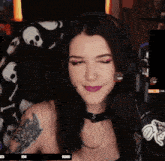 a woman wearing headphones and a choker smiles in front of a microphone with a pepe meme on her face