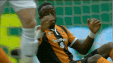 a soccer player wearing a jersey that says " sportpesa " on it