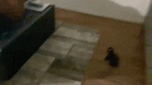 a blurry picture of a person walking down stairs in a room .