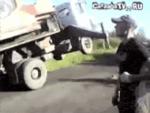 a man is standing in front of a truck that is on the side of the road and says carambatv.ru on the bottom