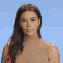 a woman wearing a turtleneck sweater and a ring is giving the middle finger .