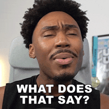 a man with a beard is making a face and says " what does that say "