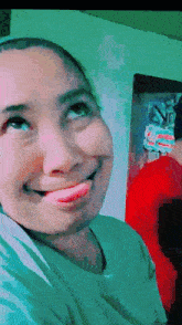 a woman is making a funny face with her tongue sticking out