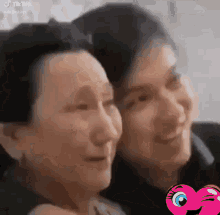 a young man and an older woman are posing for a picture together and smiling .