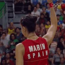 a woman in a red tank top that says marin spain on the back