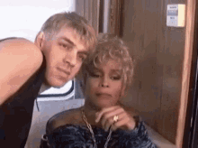 a man and a woman are posing for a picture .